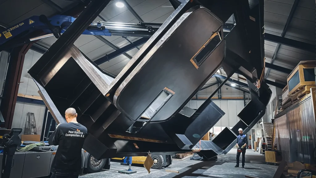 Large boat component being tilted in the workshop