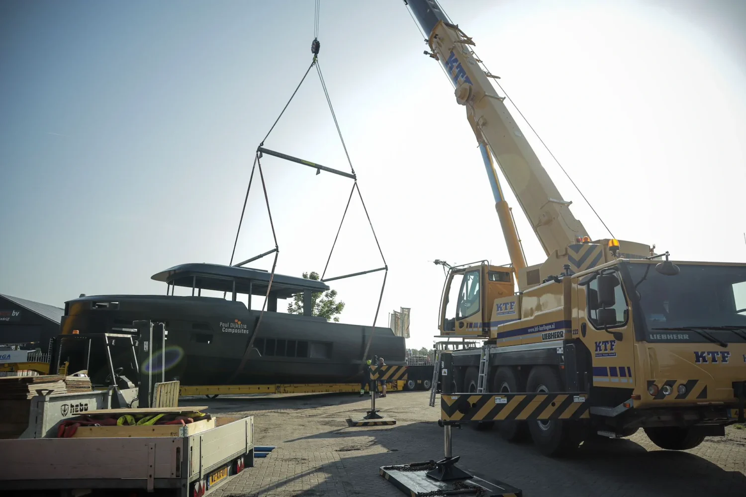 Crane lifting a yacht superstructure onto a boat hull