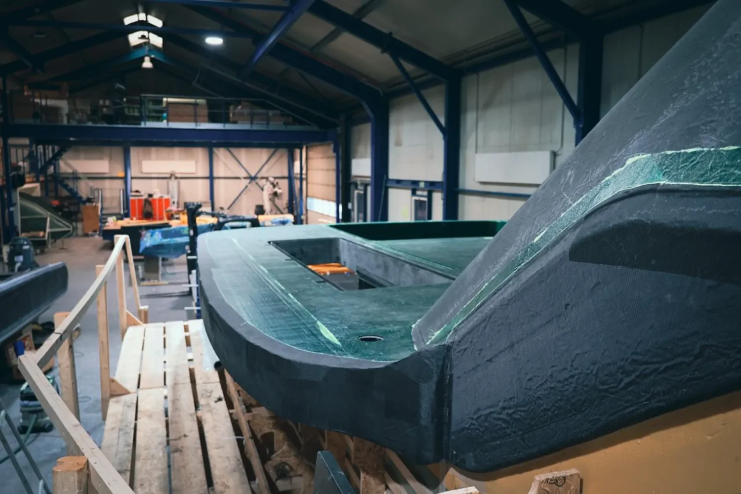 Curved dark yacht superstructure under construction