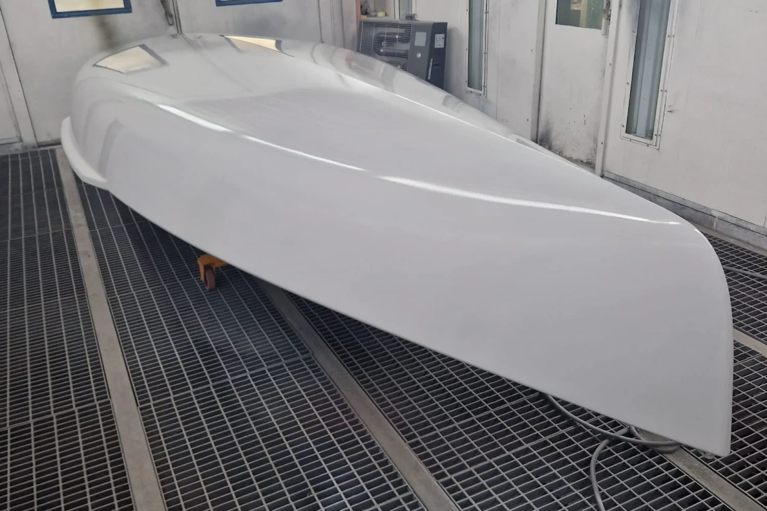 White boat hull in a spray booth