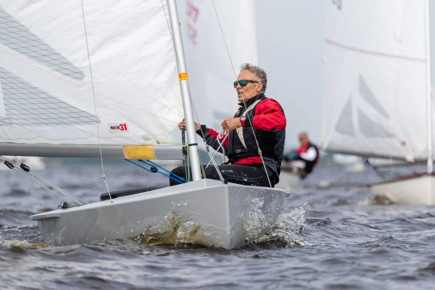 Sailor in a small grey racing boat
