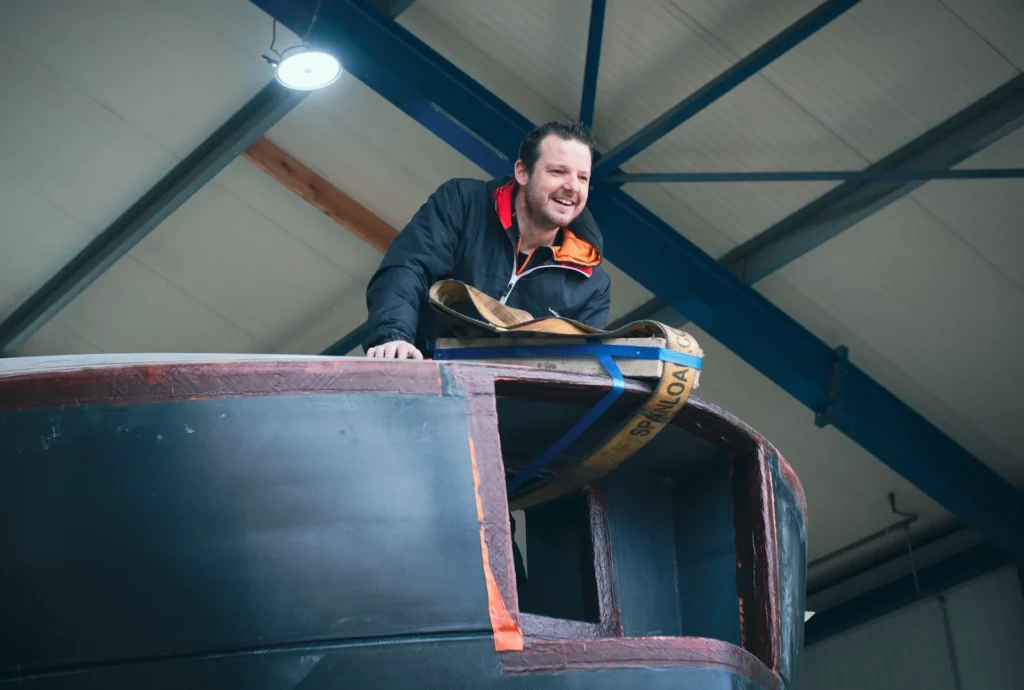 Employee beside the edge of a dark yacht superstructure
