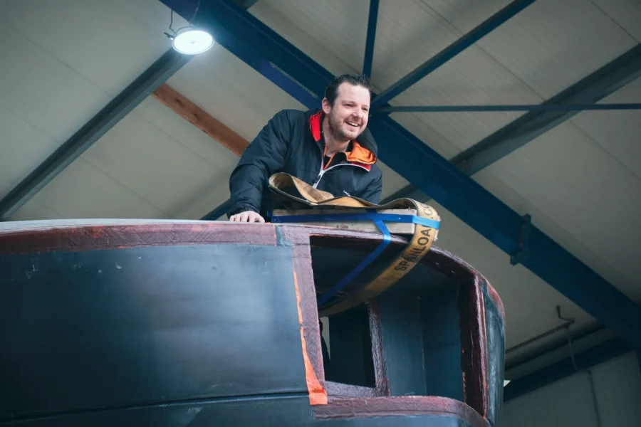 Employee beside the edge of a dark yacht superstructure