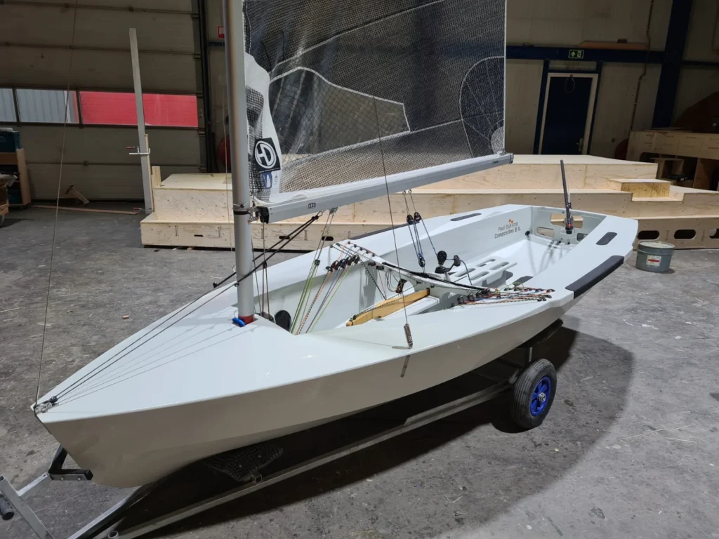 Small white sailboat on a boat trailer