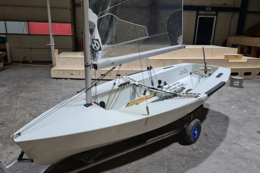 Small white sailboat on a boat trailer