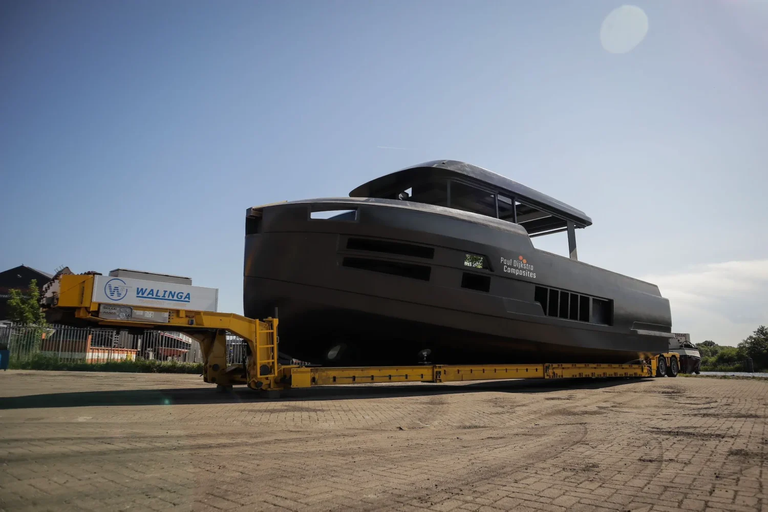 Dark motor yacht hull on a transport trailer