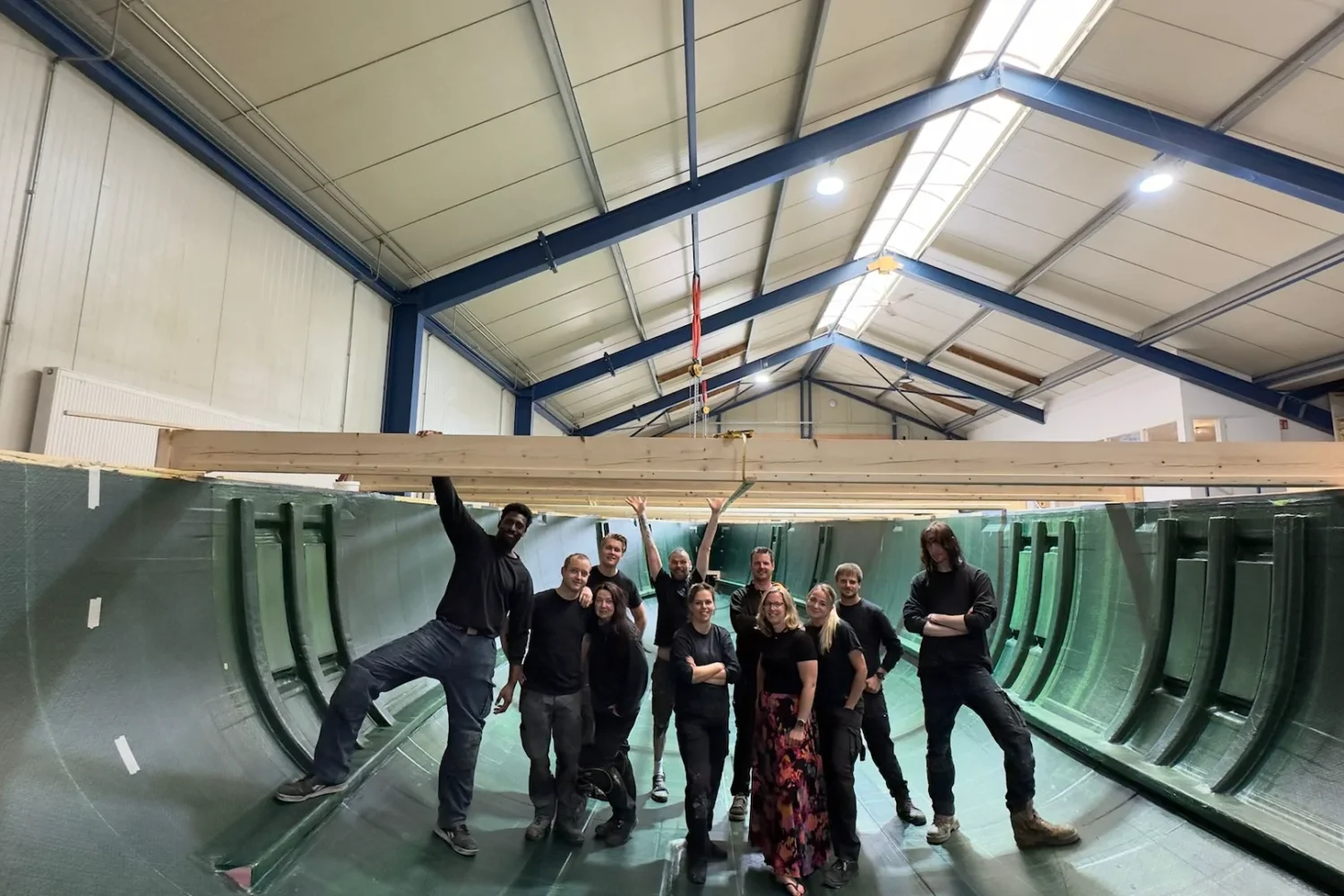 Team in an open boat hull in the workshop