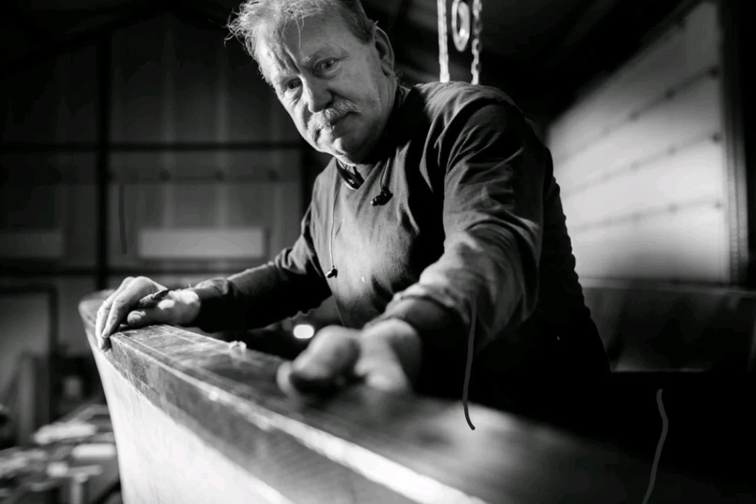 Employee sanding a long composite component