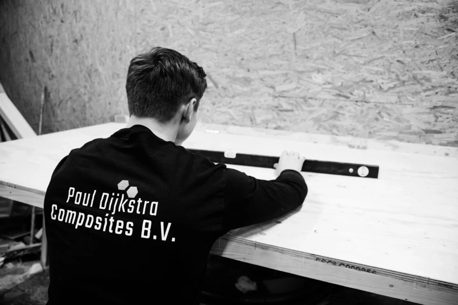 Employee checking a panel with a spirit level