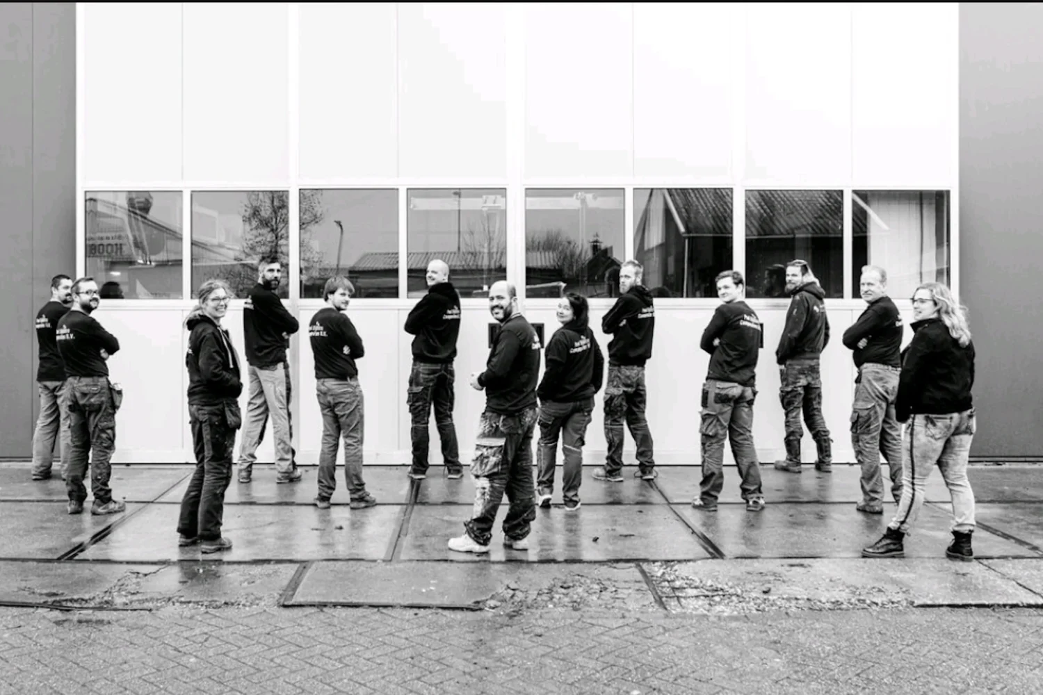 Employees lined up in front of the workshop