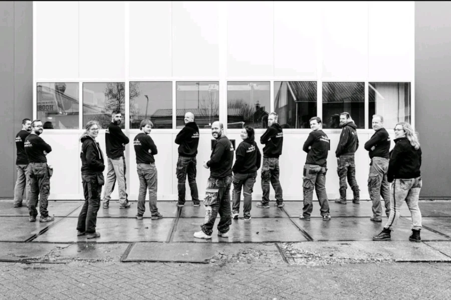 Employees lined up in front of the workshop