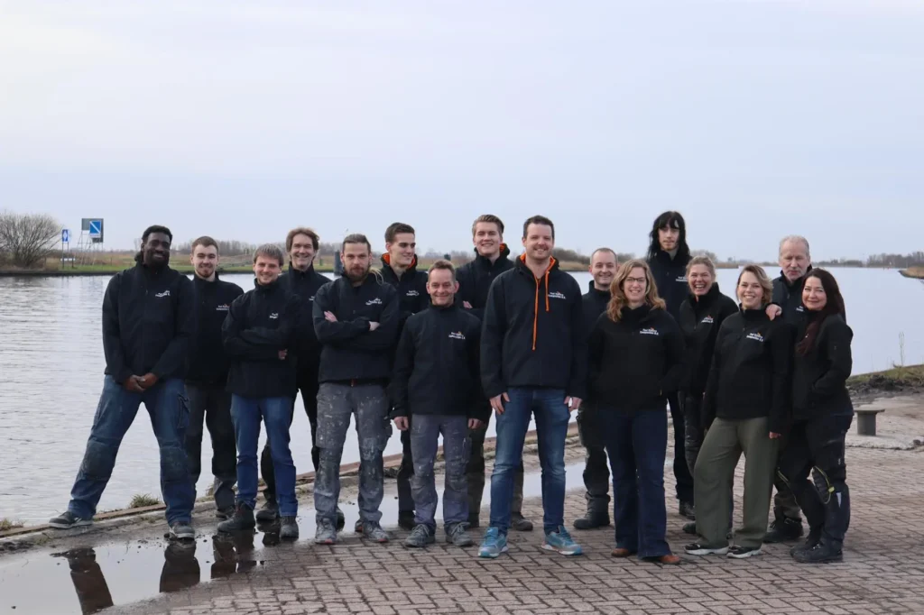 Team photo by the water