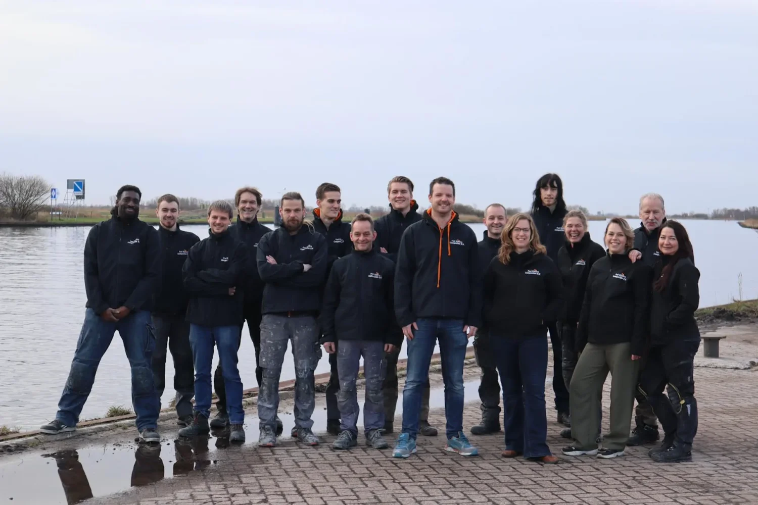 Team photo by the water