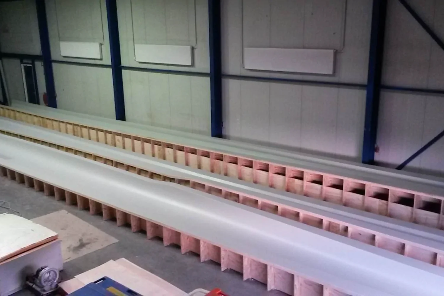 Long mold sections lined up beside one another in the workshop