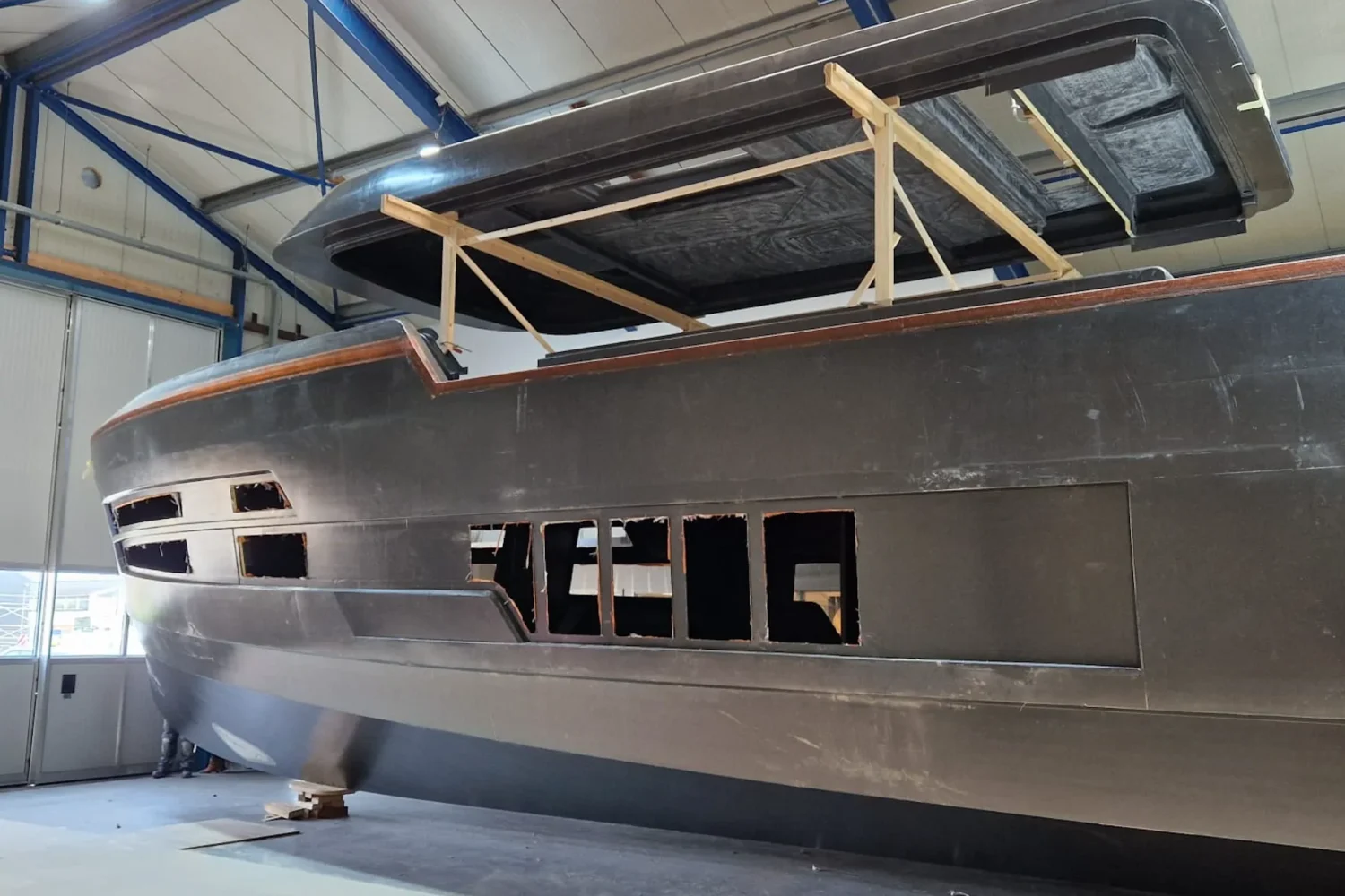Dark boat hull with the superstructure above it