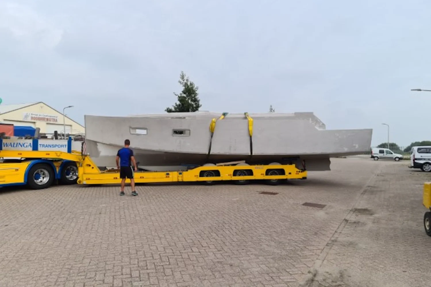 White boat hull on a low loader