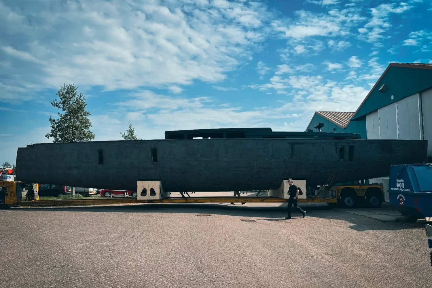 Dark-colored boat hull outside on supports