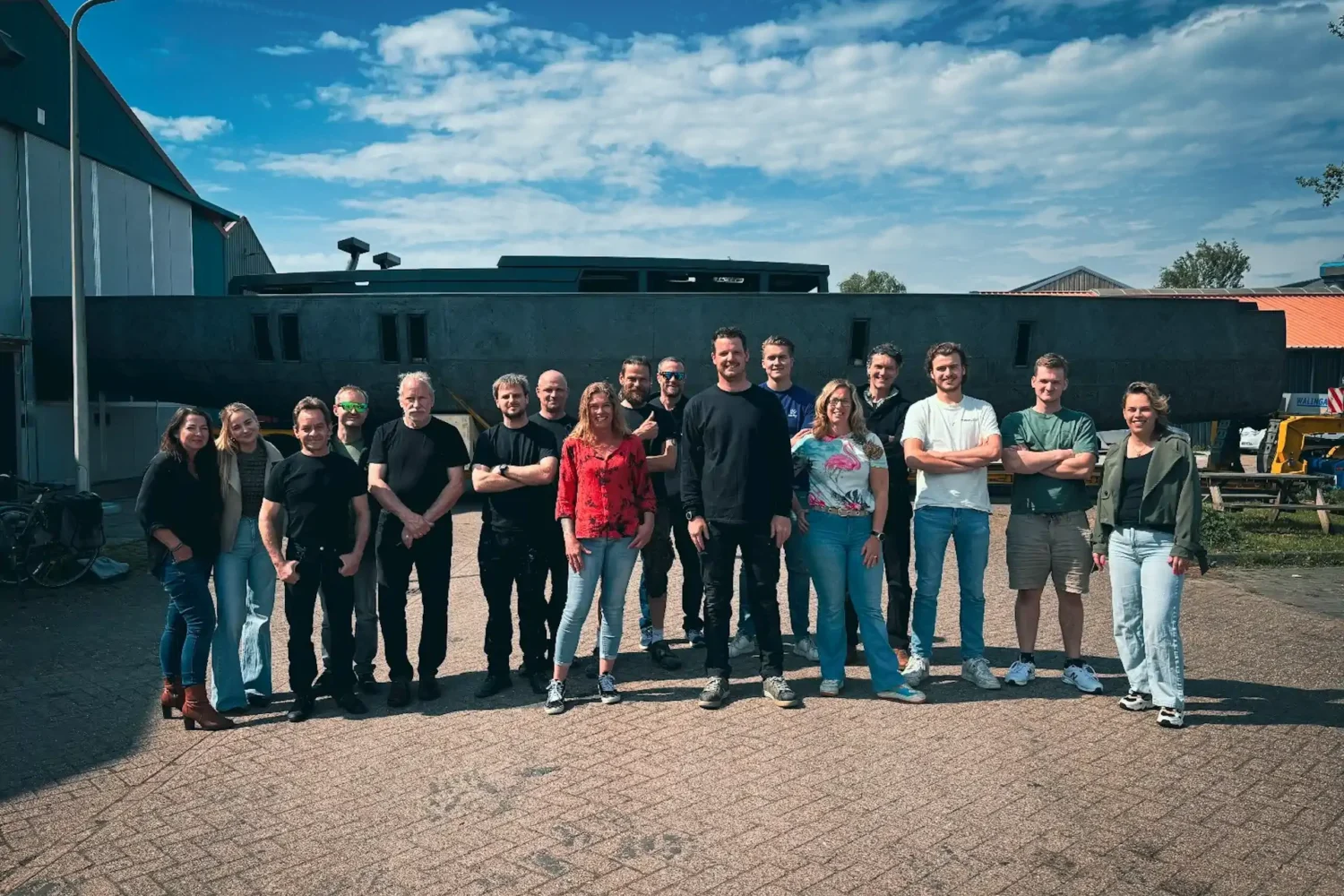 Team photo outside in front of the workshop