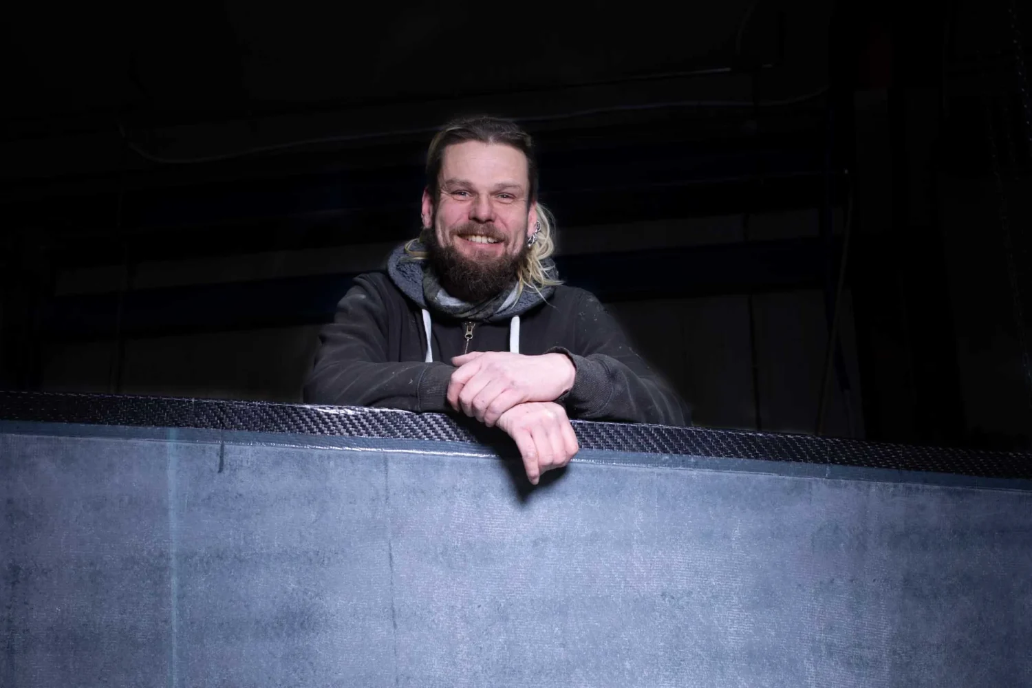 Employee behind a dark composite panel