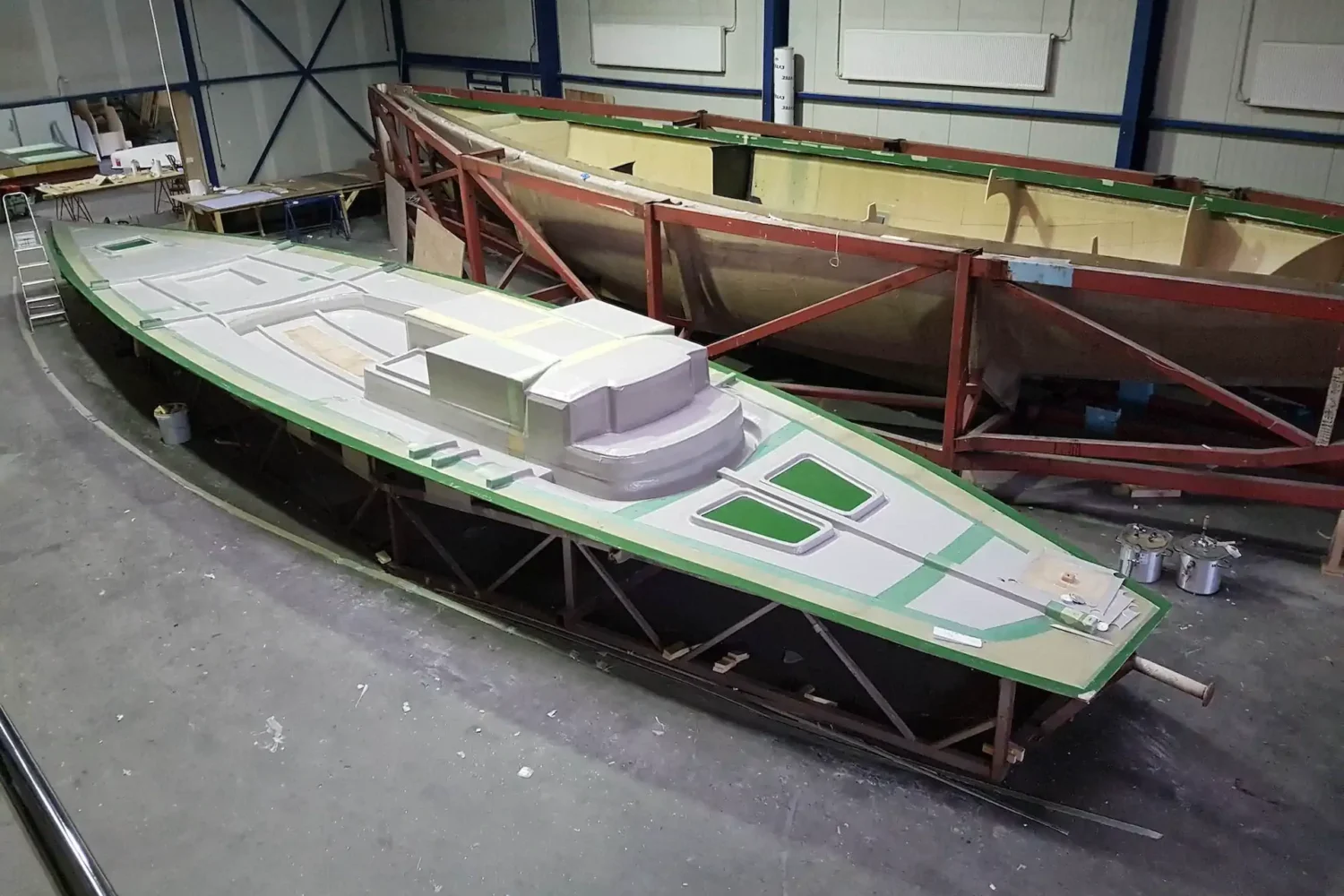 Boat deck and mold side by side in the workshop