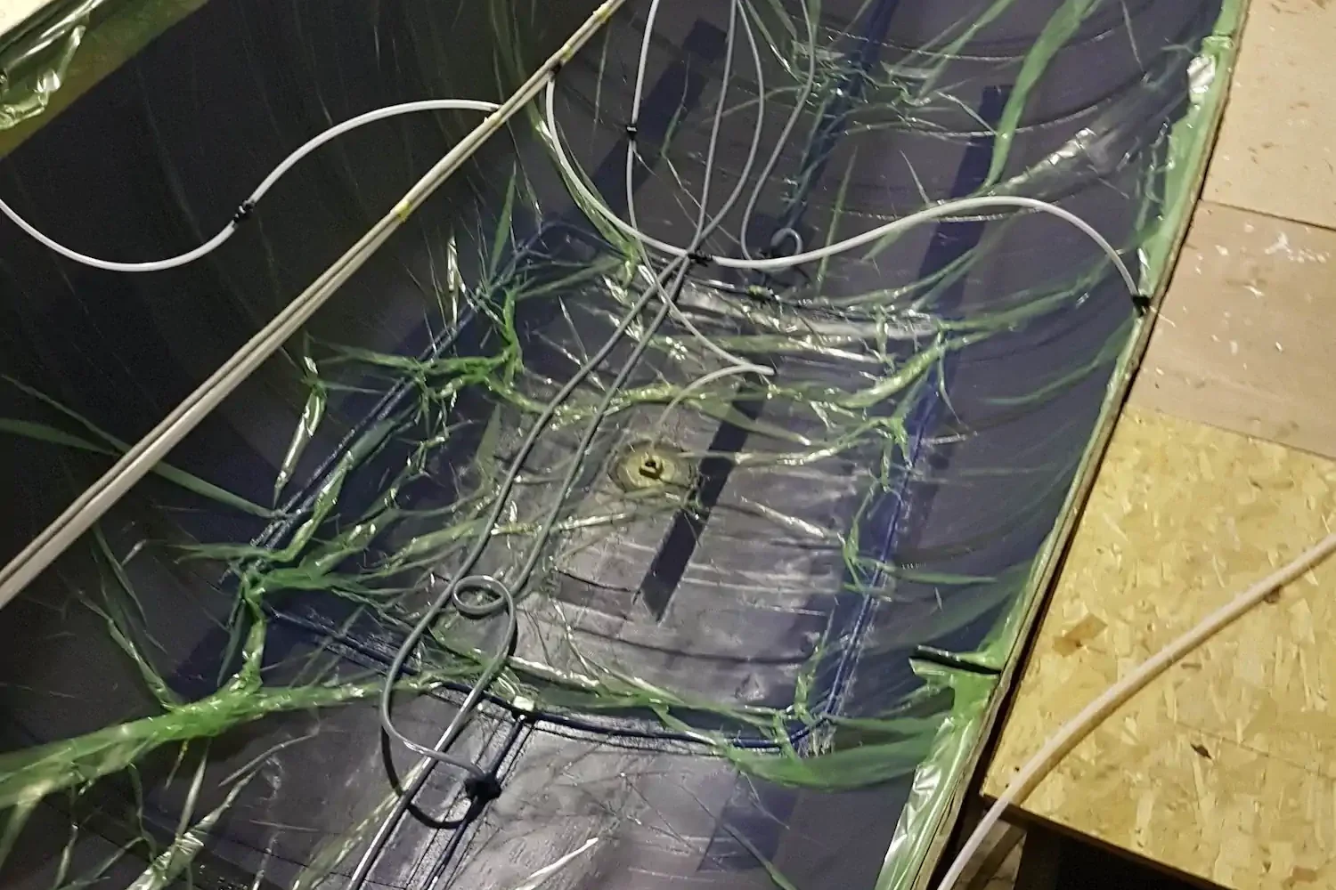 Detail of vacuum bagging film and hoses in a boat hull