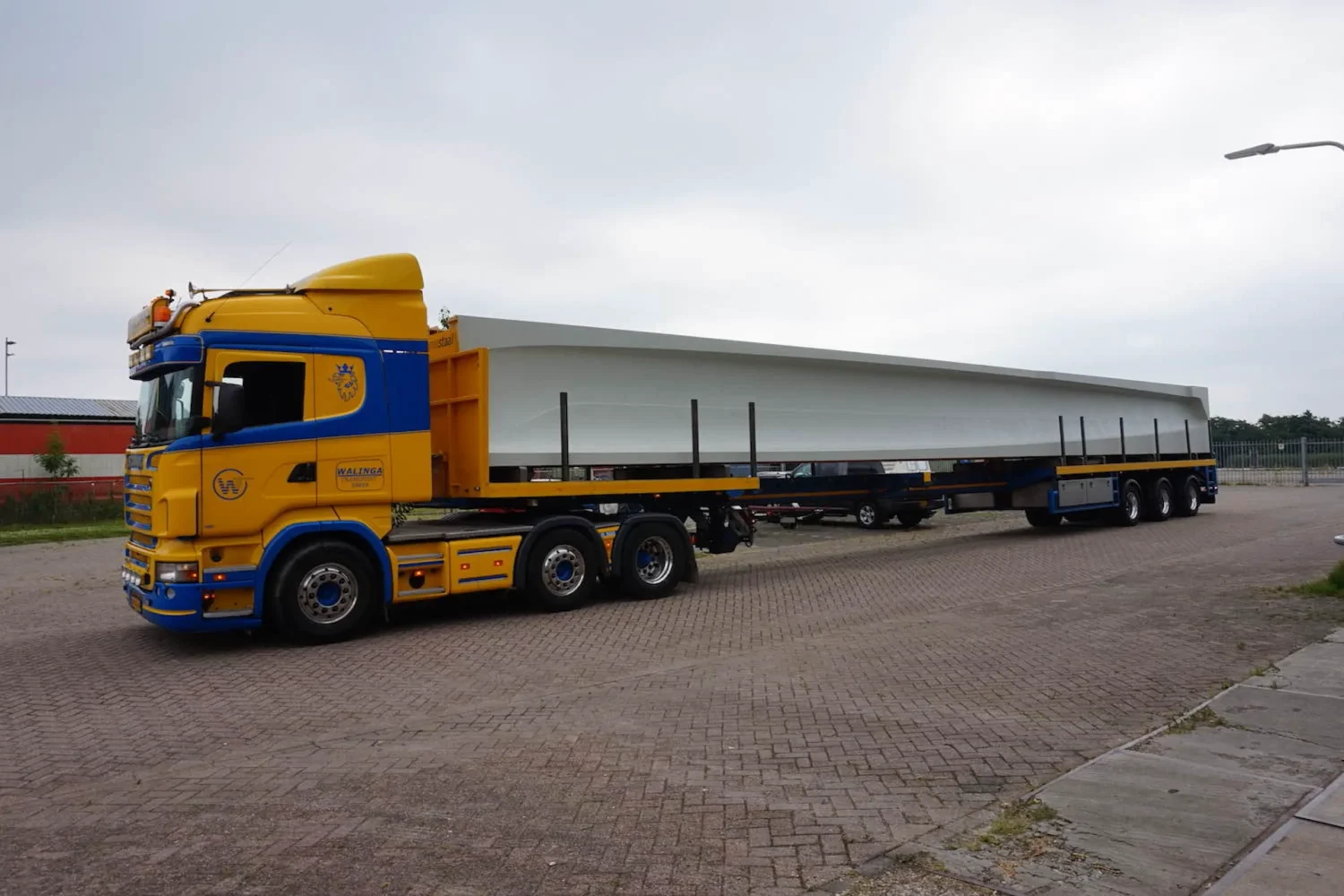 Truck carrying a long load on site
