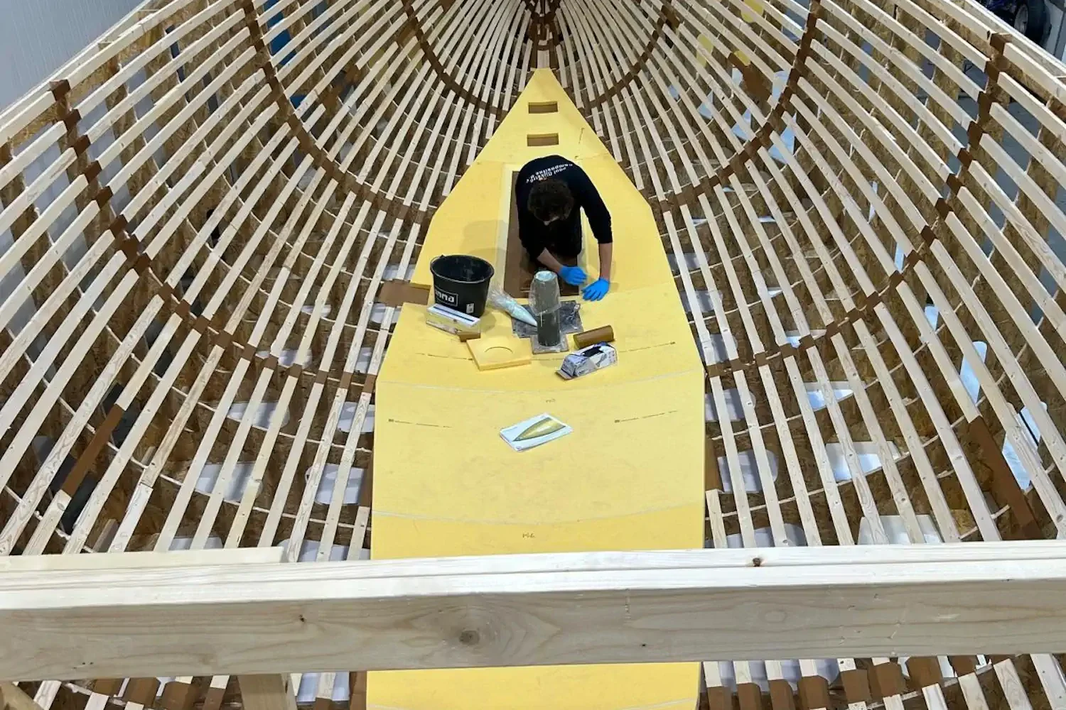 Wooden frame for a boat hull with a yellow central section