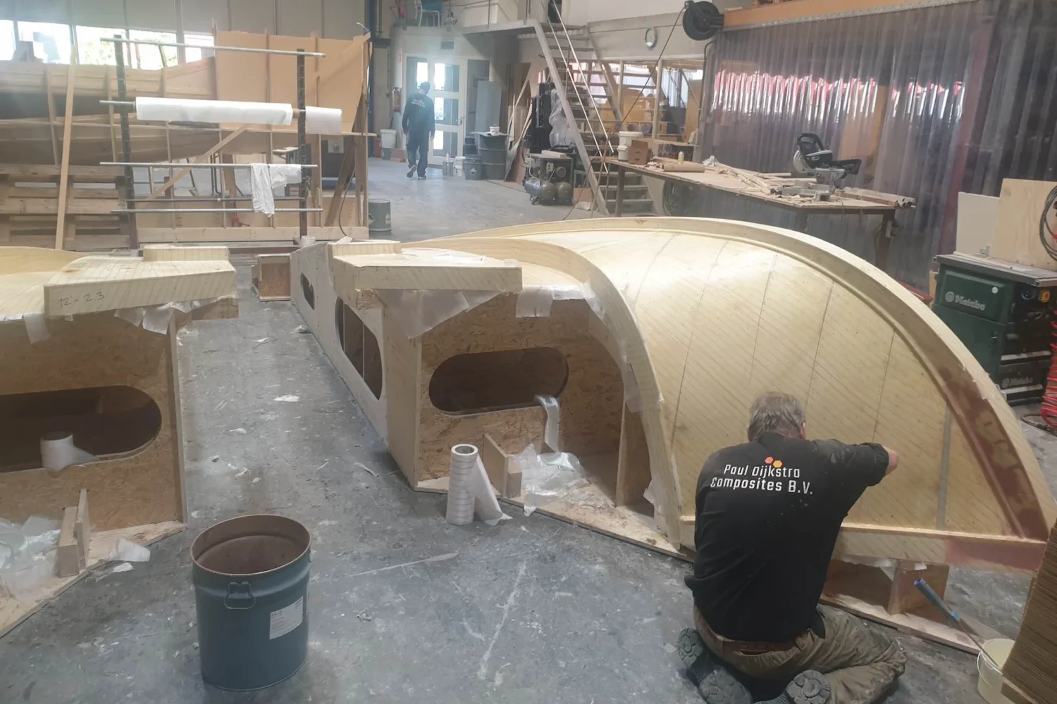 Employee working on the inside of a curved mold