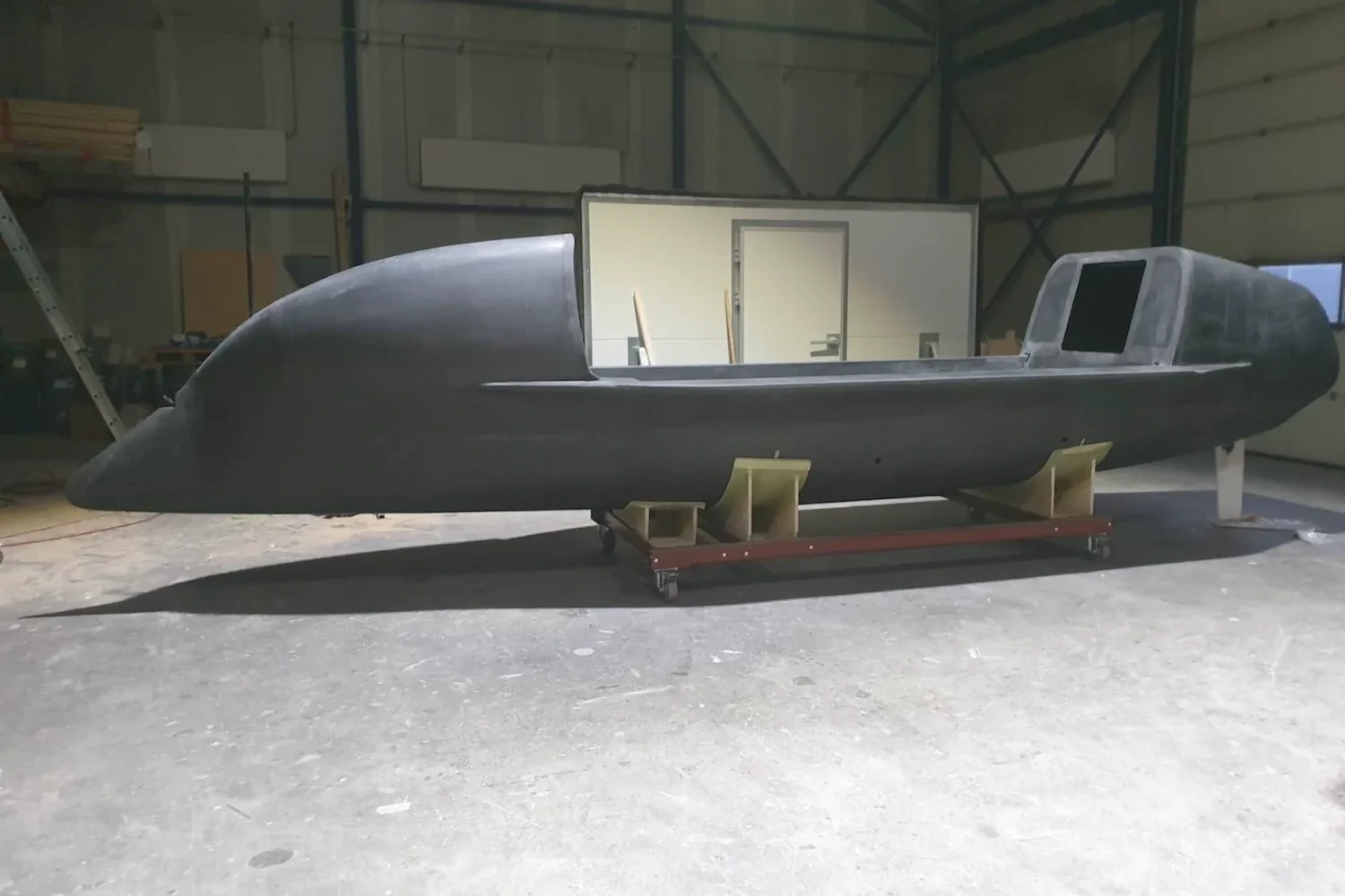 Dark ocean rowing boat on wooden supports