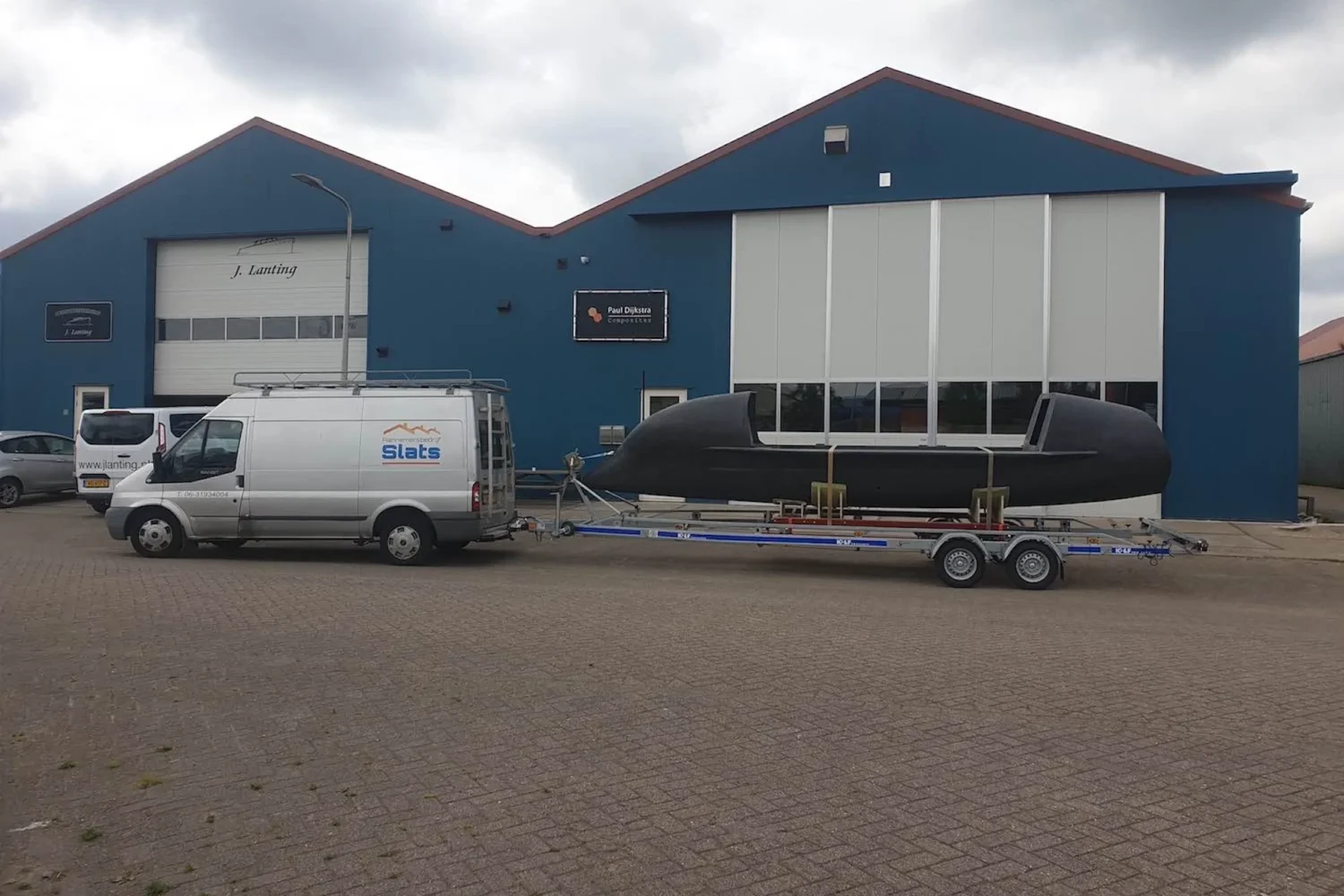 Boat hull on a trailer outside the workshop