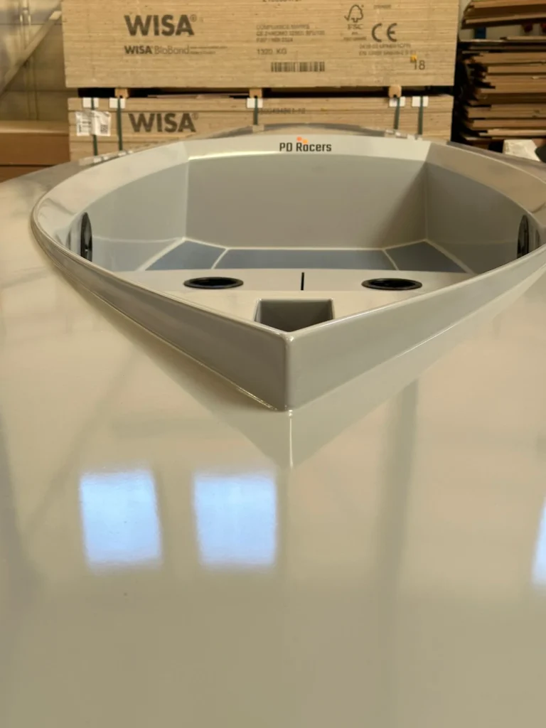White cockpit of a small sailboat in the workshop