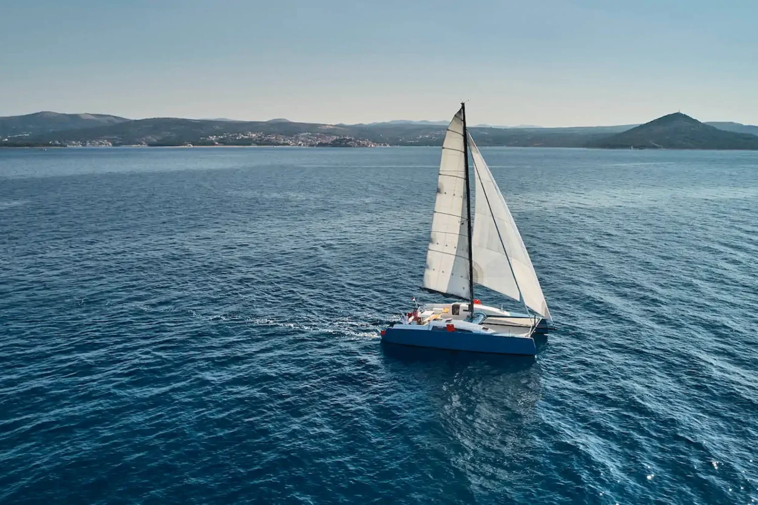 Catamaran under sail on open water