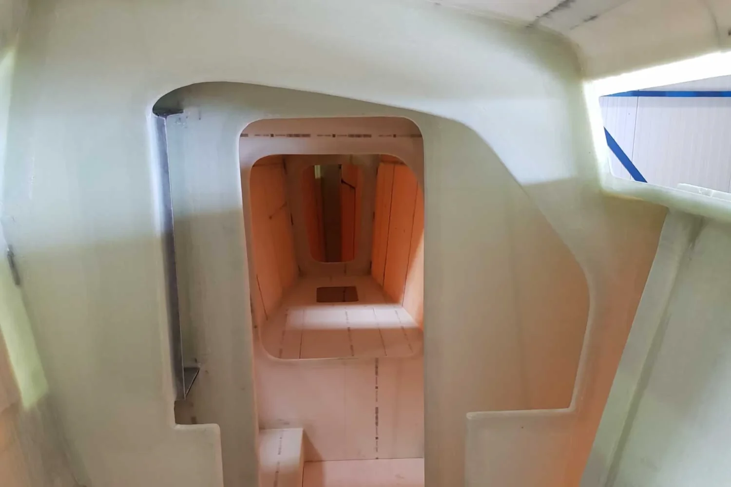 Passage between compartments of a catamaran