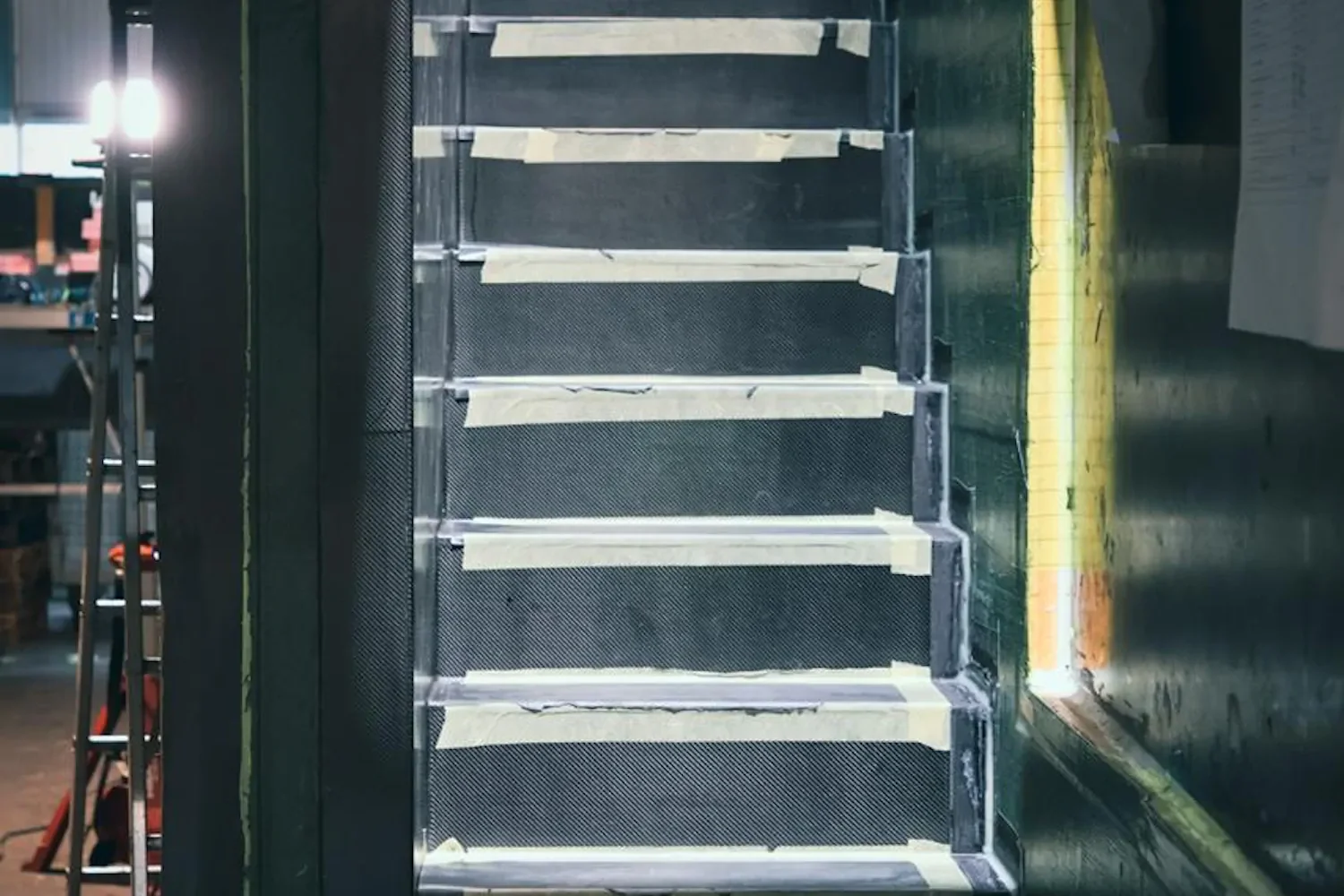 Staircase with light-coloured steps in a dark boat interior