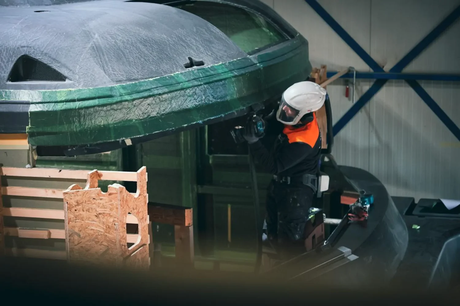 Worker beside a yacht superstructure under construction