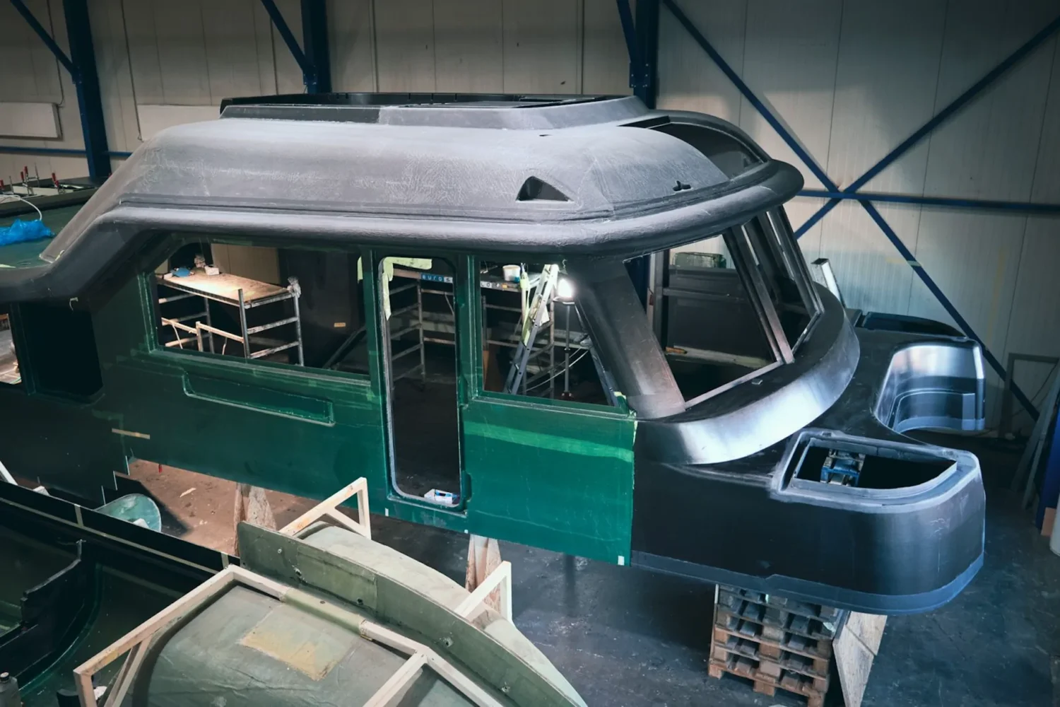 Dark yacht superstructure with window openings in the workshop
