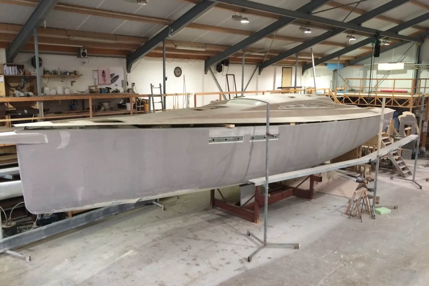 Boat hull surrounded by scaffolding in the workshop