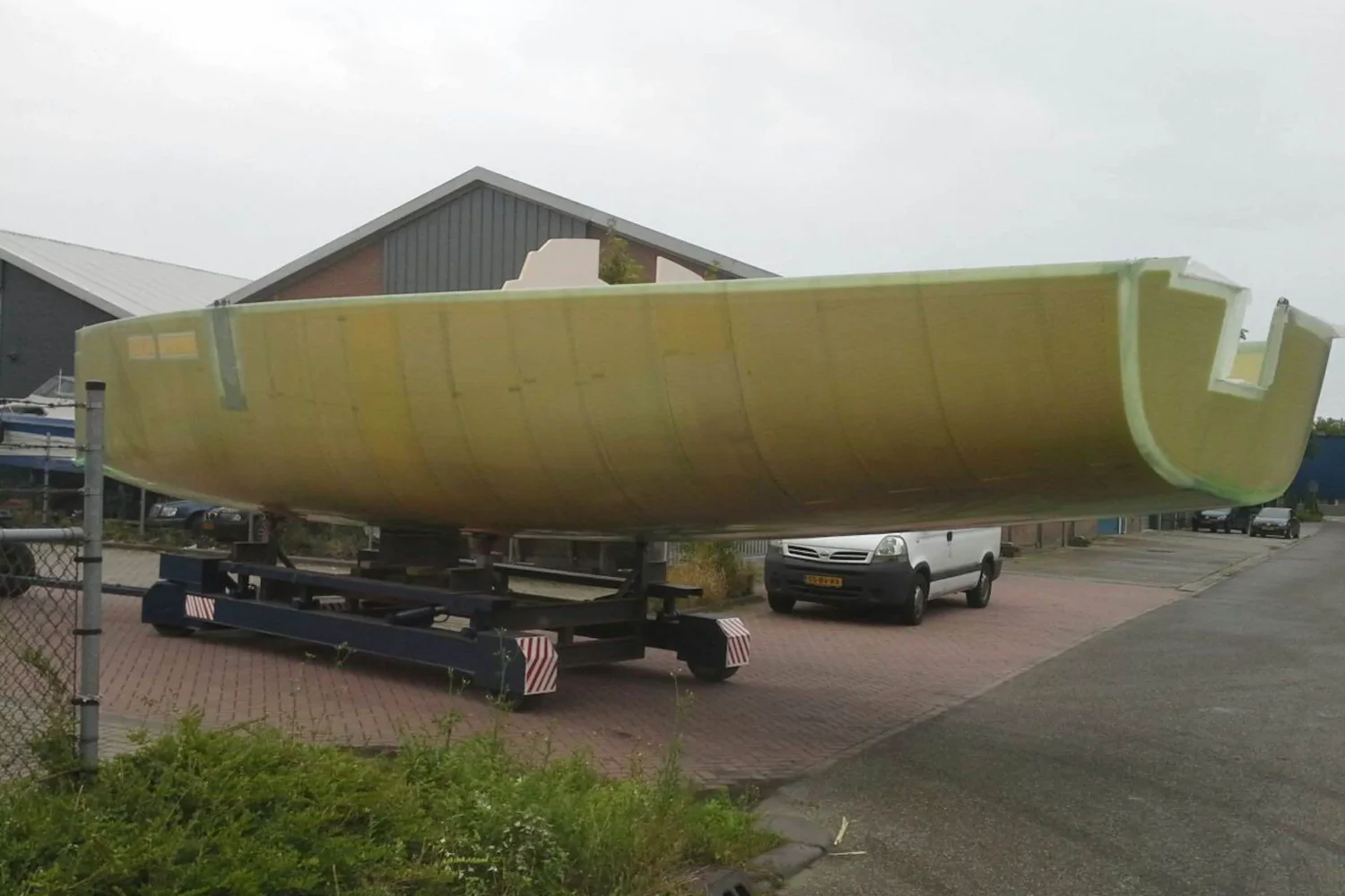 Boat hull outdoors on a transport trailer