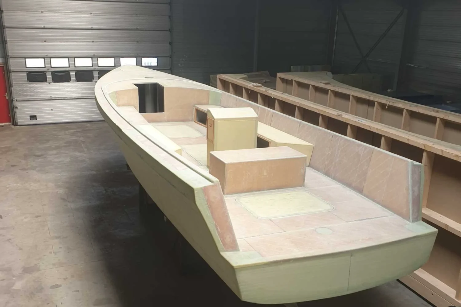 Open boat hull with bulkheads under construction