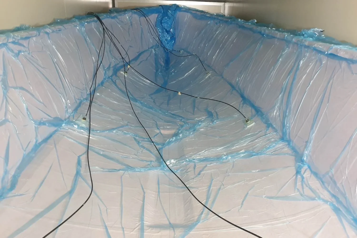 Blue vacuum film and hoses over a hull structure