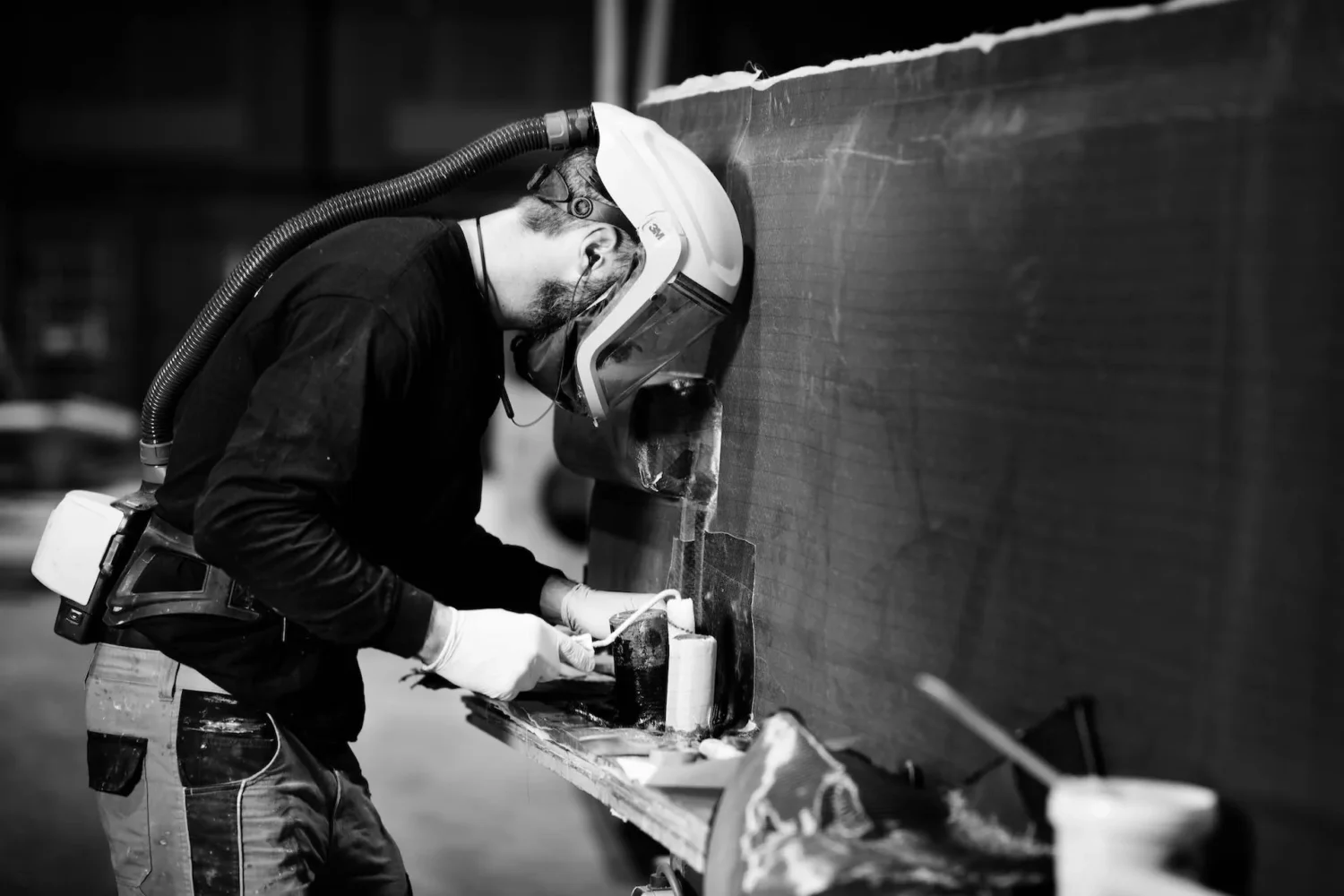 Employees working on the inside of a boat hull