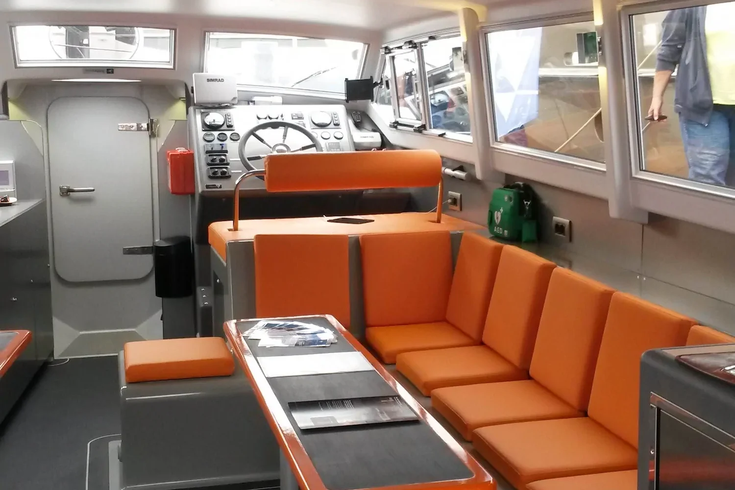 Seating area with orange sofas in the yacht interior
