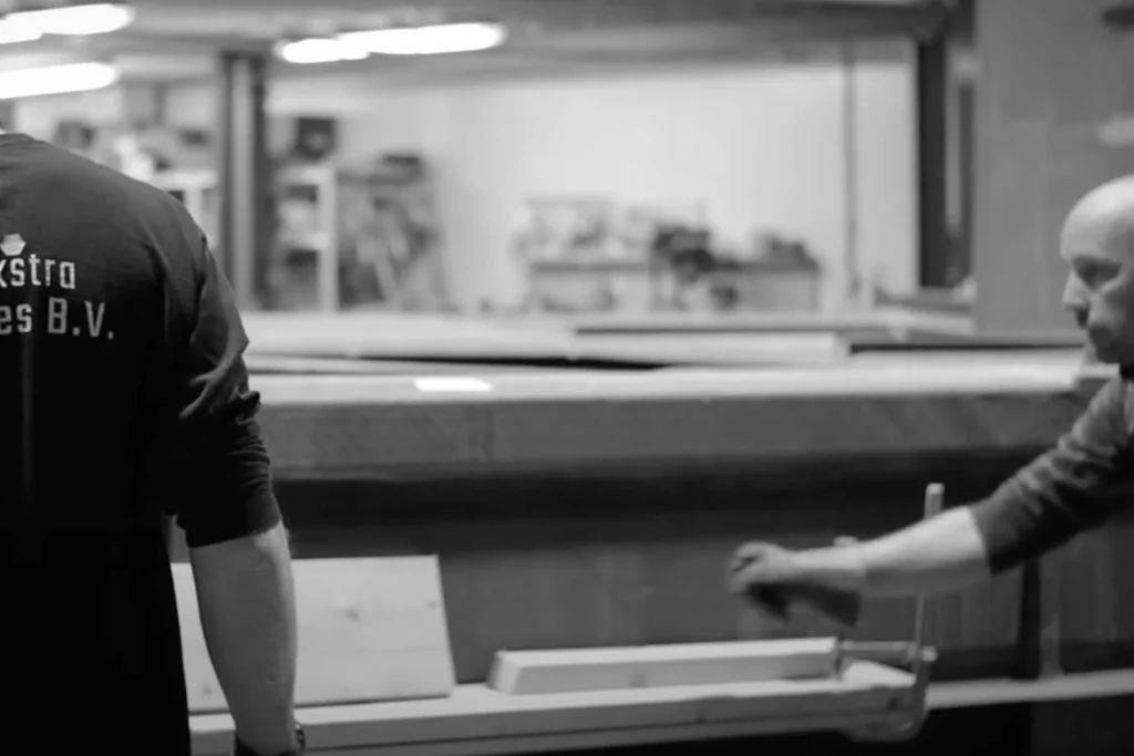 Employees confer at a workbench